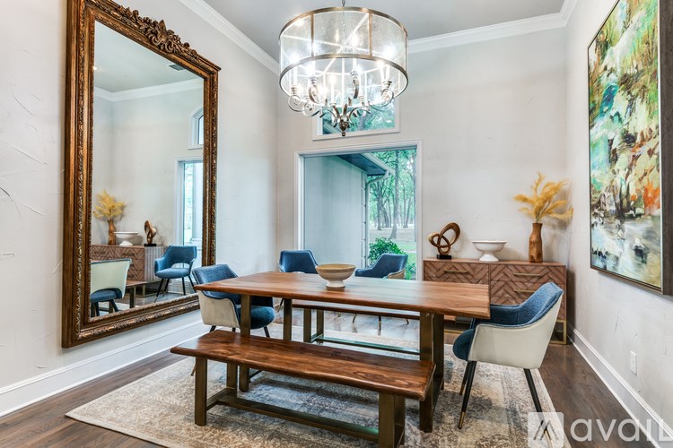 A dining room with a wooden table and blue chairs.