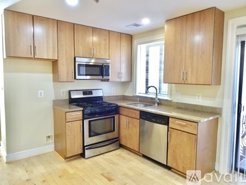 A kitchen with wooden cabinets and stainless steel appliances.