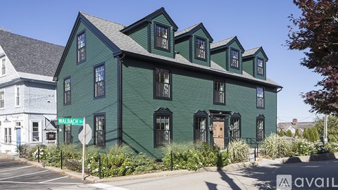 A green building with the name Walbach 4 on the front.