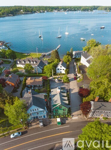 A bird's eye view of a small town with a body of water and boats.