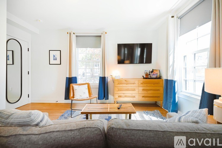 A living room with a grey couch and a wooden coffee table.