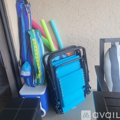 A blue suitcase with a black handle is open and has a blue bag and a black bag in it.