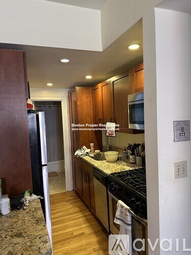 A kitchen with wooden cabinets and a stove top oven.