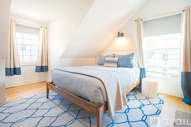 A bedroom with a bed in the middle of the room.