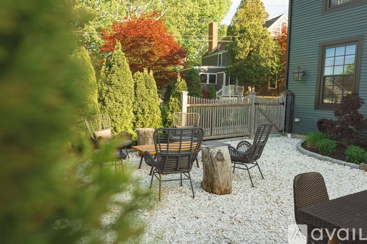 A backyard with a table and chairs.