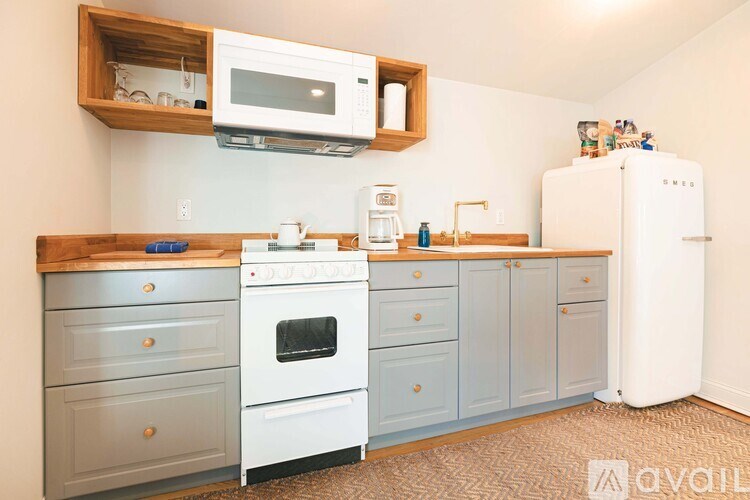 A kitchen with a white refrigerator, a white oven, and a white microwave.