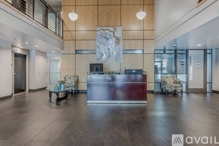 A reception area with a marble sculpture on the wall.