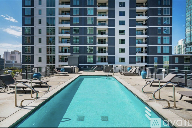 A large swimming pool in front of a tall building.