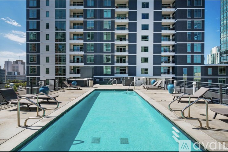 A large swimming pool in front of a tall building.