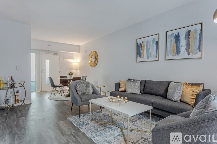 A living room with a grey couch and a white coffee table.