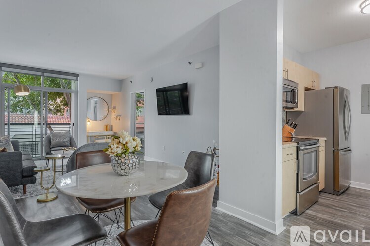 A modern kitchen with a dining table and chairs.