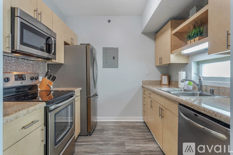 A kitchen with a stove top oven and a refrigerator.