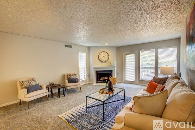 A living room with a fireplace and a large painting on the wall.