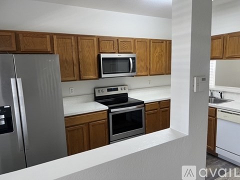 A kitchen with wooden cabinets and stainless steel appliances.