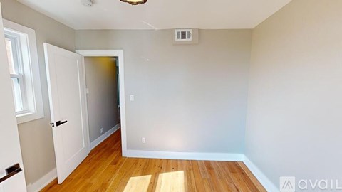A room with a wooden floor and a ceiling fan.