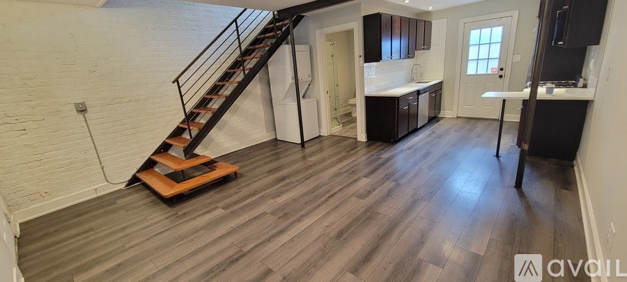 A bare wall with a white brick pattern and a metal pipe running up it.