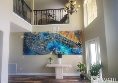 A large peacock mural is the centerpiece of this well-lit room.