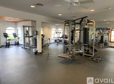 A large outdoor swimming pool surrounded by palm trees.