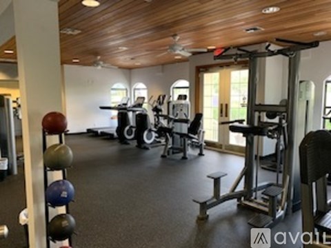 A gym with a variety of equipment including weights and machines.