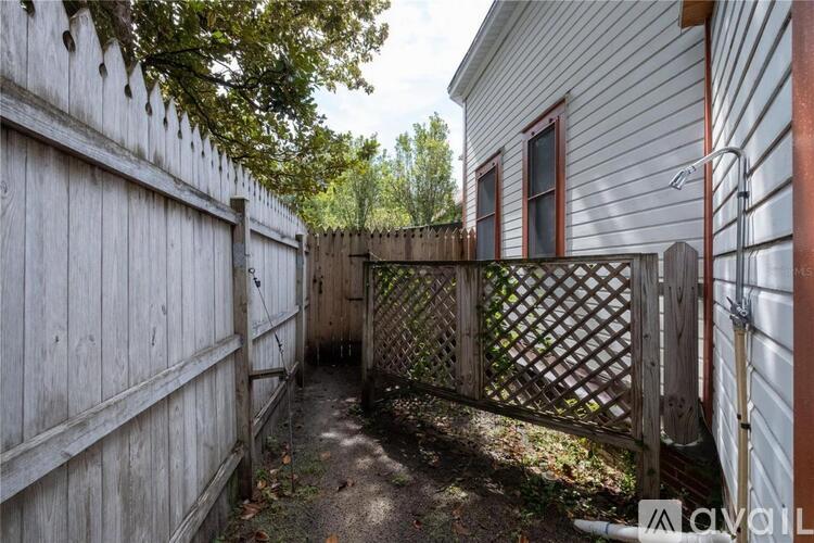 A wooden fence and gate in front of a house.