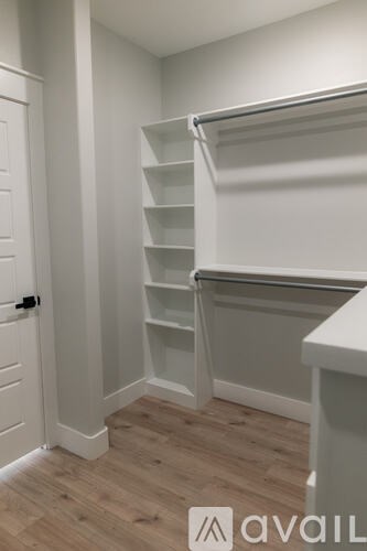 A white closet with a sliding door and shelves.