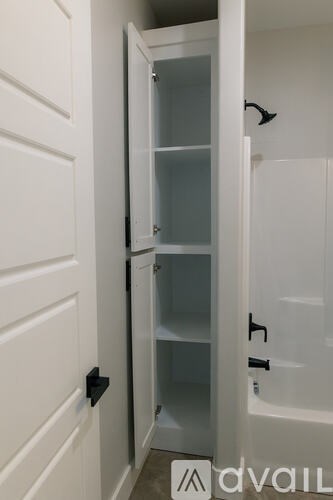 A white door with a glass panel and black hinges.