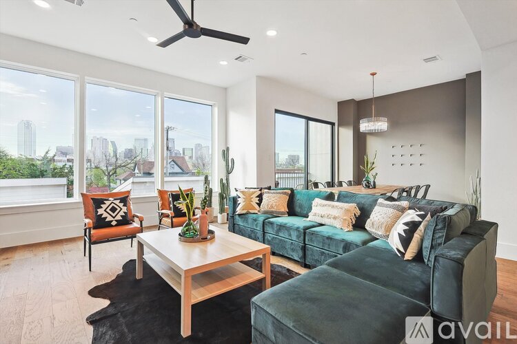 A living room with a green couch and a wooden coffee table.