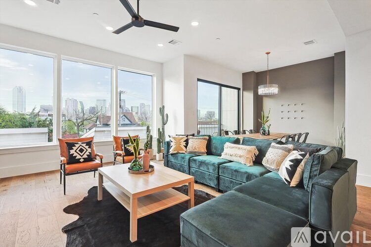 A living room with a green couch and a wooden coffee table.