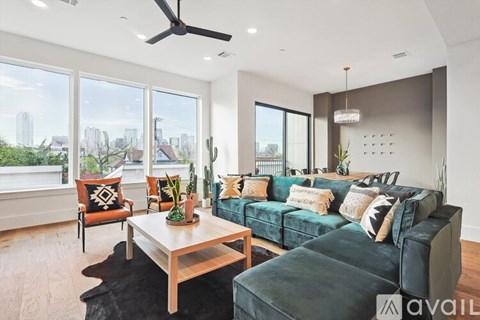 A living room with a green couch and a wooden coffee table.