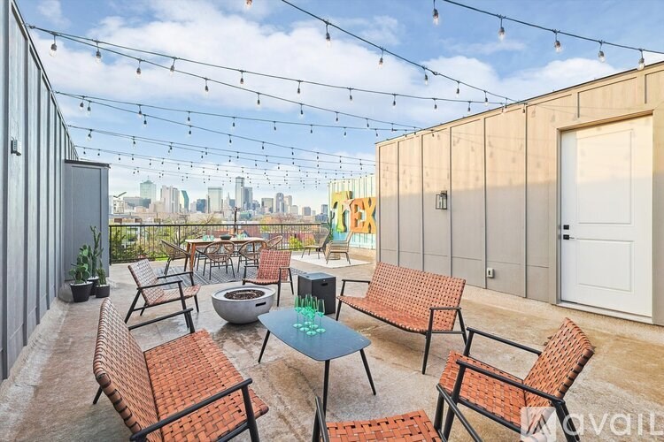 A patio with a table and chairs is set up on a rooftop.
