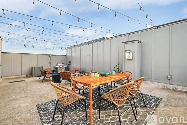 A patio with a table and chairs is set up for outdoor dining.