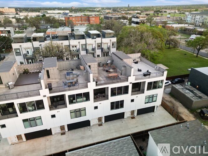 A large white building with a balcony in the middle of it.