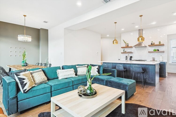 A living room with a blue couch and a wooden coffee table.