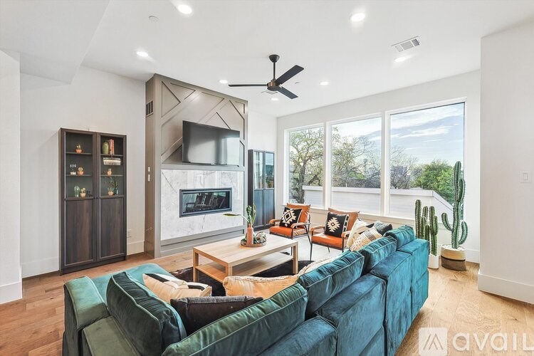 A living room with a blue couch and a flat screen TV.
