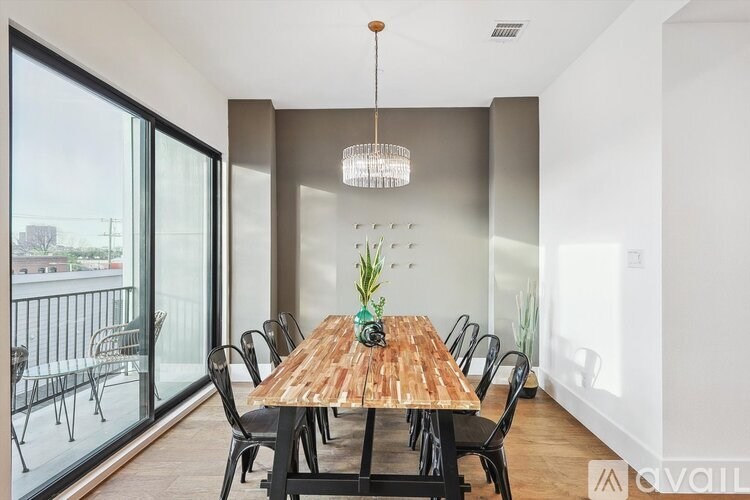 A dining room with a wooden table and chairs.