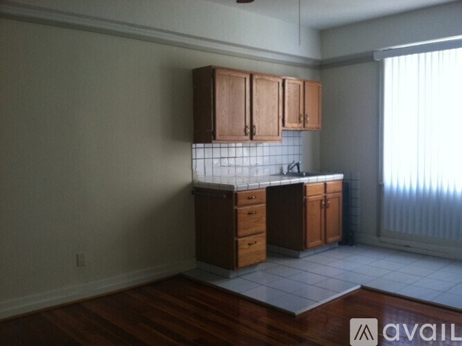 A kitchen with wooden cabinets and a tiled backsplash.