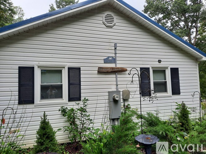 A house with a satellite dish on the roof.