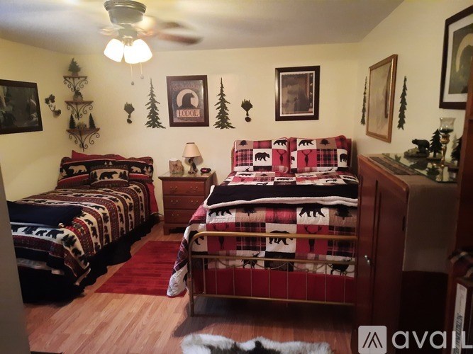 A room with two beds and a dresser.