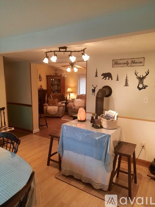 A dining room with a table set for a meal.