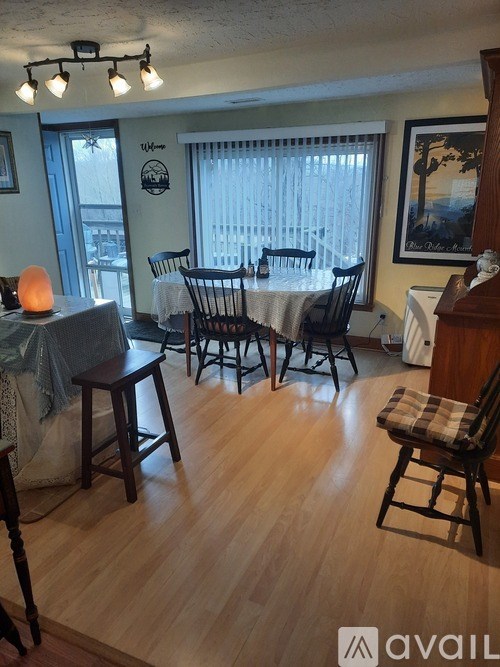 A dining room with a table set for six.