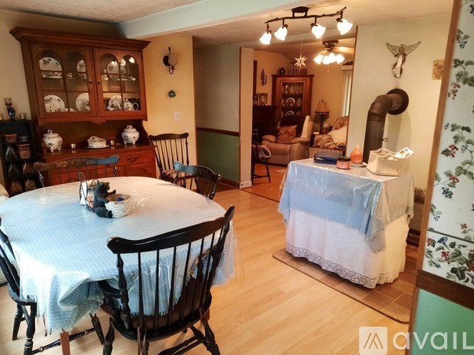 A dining room with a round table and chairs.