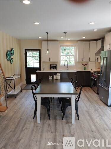 A kitchen with a table and chairs in the middle of the room.