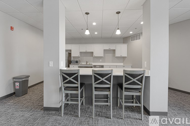 A kitchen area with a table and chairs.