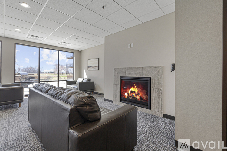 A modern living room with a fireplace and a large couch.
