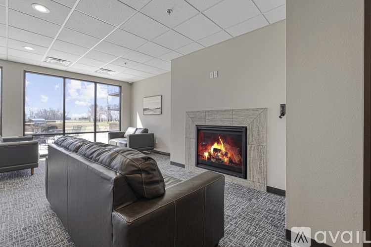 A modern living room with a fireplace and a large couch.