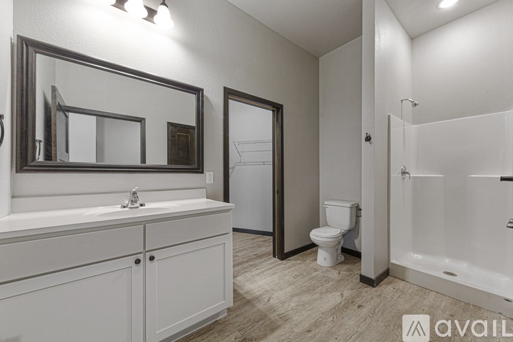 A bathroom with a white sink and a white toilet.