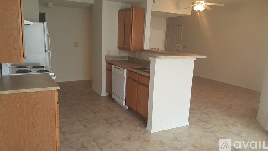 A kitchen with wooden cabinets and a white countertop.