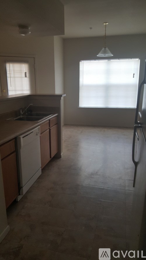 A kitchen with brown cabinets and a white fridge.