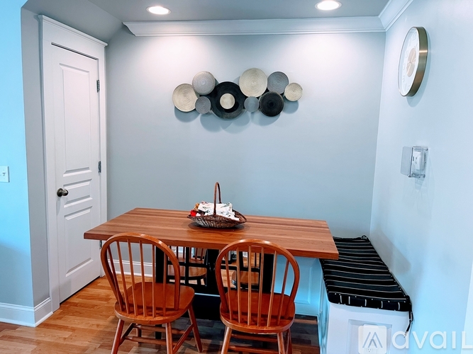 A dining room with a wooden table and chairs.