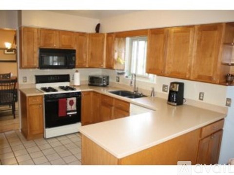 A kitchen with wooden cabinets and a white countertop.
